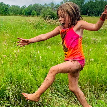 children in tall grass playing and laughing