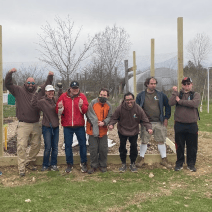 A group of people posing for a picture in a field.