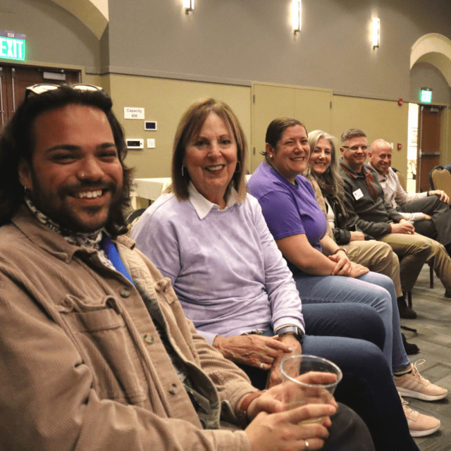 A group of people sitting in a room.