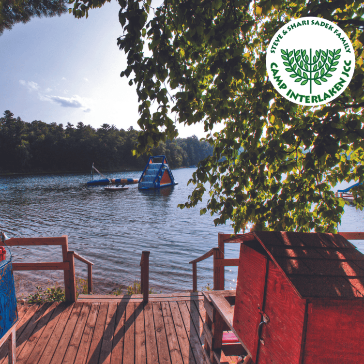 A wooden deck overlooking a lake.