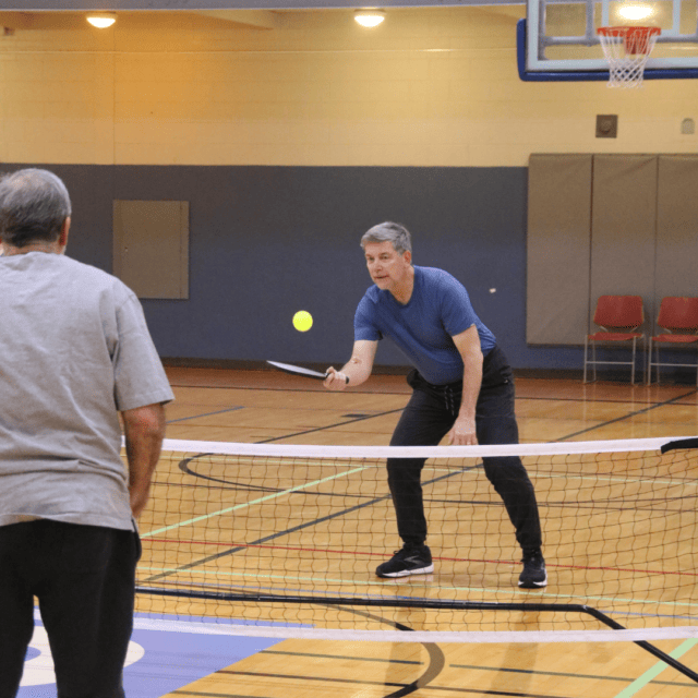 Two men playing a game of tennis.