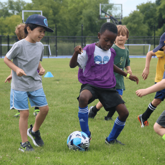 A group of kids playing soccer.