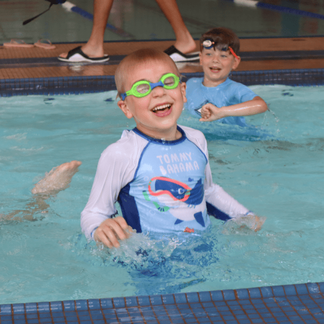 A boy wearing goggles in a swimming pool.