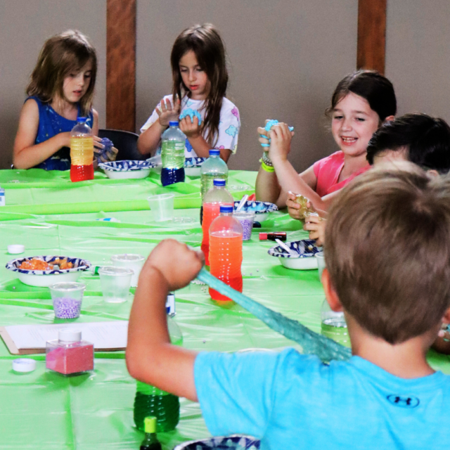 A group of children sitting at a table.