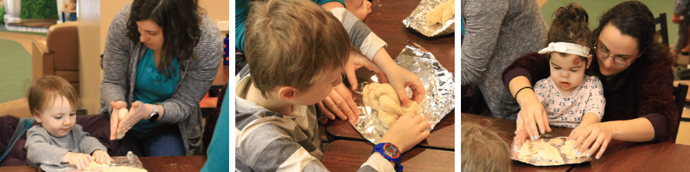 Adults and children sit at tables, shaping dough on foil with their hands, engaging in a baking or crafting activity together.