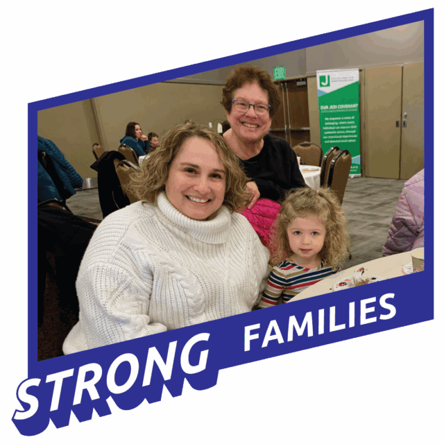 Two women and a young girl sit together at a table, smiling at the camera. Text on the image reads "STRONG FAMILIES." A banner and chairs are visible in the background.