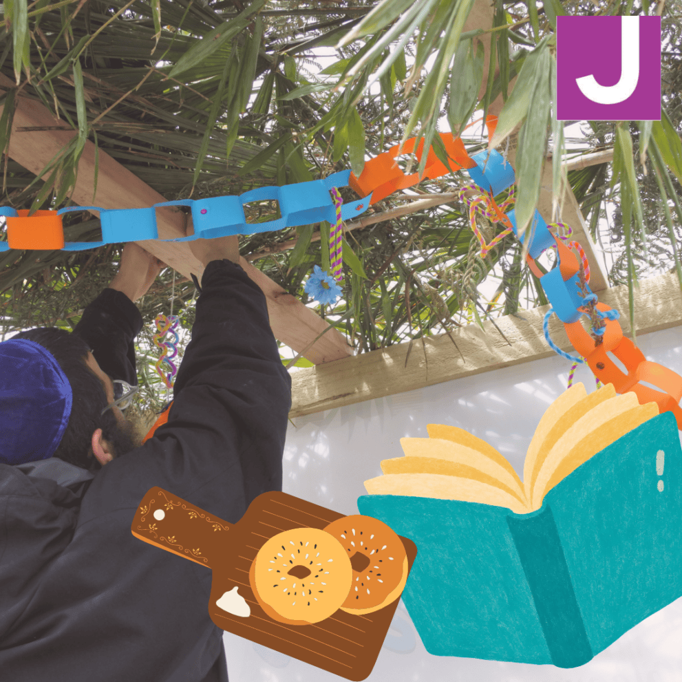 A person decorates a wooden sukkah with colorful paper chains. Illustrations of a book and bagels, plus a purple “J” logo, are in the corner.